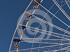 Close-up view of the top of a big Ferris wheel in amusement park Wurstelprater in Vienna, Austria with white frame.