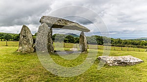 A close up view towards the coast through the ancient burial chamber at Pentre Ifan in the Preseli hills in Pembrokeshire, Wales