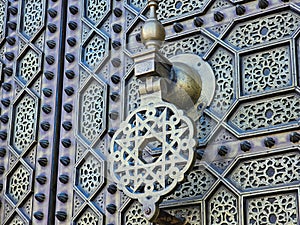 close up view of a traditional Moroccan copper and metal door at the Mohammed V mausoleum in Rabat Morocco