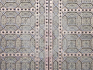 close up view of a traditional Moroccan copper and metal door at the Mohammed V mausoleum in Rabat Morocco