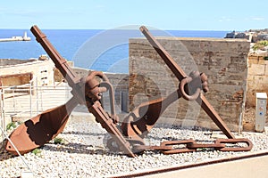 Close-up view of two large rusted ship anchors