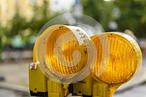 Close up view of two orange warning lights on a construction site