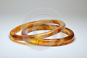 Close up view of two vintage bakelite bangle bracelets on white background