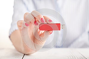 Close up view of usb flash pendrive in female hand