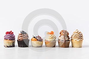 Close up view of various sweet cupcakes on cake stand