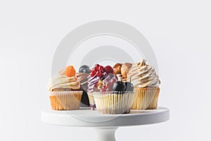 Close up view of various sweet cupcakes on cake stand