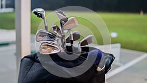 The close up view of the various type of golf club in the stand beg at the golf driving range
