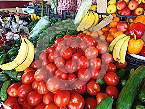 Close up view of vegetable department with variety of organic vegetables, fruits and greens on a farmer market shelves