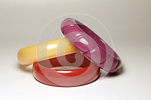 Close up view of vintage bakelite bangle bracelets on white background