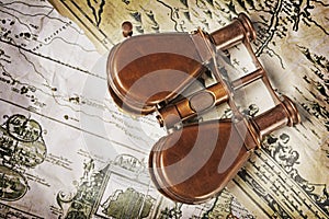 Close-up view of a vintage binoculars on an old retro map