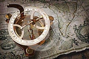 Close-up view of a vintage compass on an old retro map