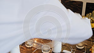 Close-up view of waiter lighting candles on festive table