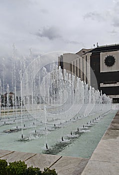 A close-up view of water fountains in front of the National Palace of Culture