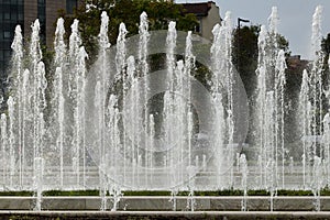 A close-up view of water fountains in front of the National Palace of Culture