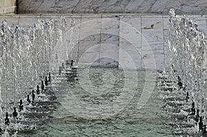 A close-up view of water fountains in front of the National Palace of Culture in Sofia