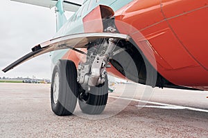 Close up view of wheels. Turboprop aircraft parked on the runway at daytime