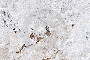 Close up view on white aged concrete walls with cracks and lots of structure