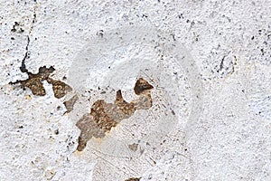 Close up view on white aged concrete walls with cracks and lots of structure