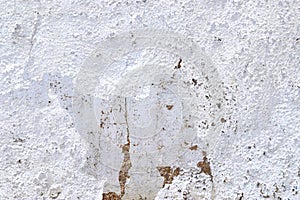 Close up view on white aged concrete walls with cracks and lots of structure