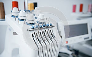 Close up view of white automatic sewing machine at factory photo