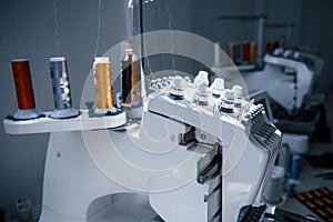 Close up view of white automatic sewing machine at factory photo