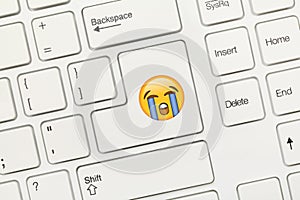 White conceptual keyboard - Key with Sob Emoji symbol photo