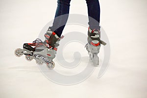 Close up view, on white, of inline skate or rollerblade on the ice rink