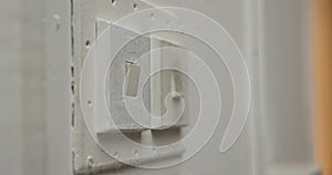 Close Up View of White Light Switch on a Wall