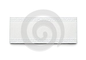A close-up view of a white textured rectangular object against a white background
