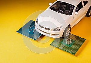 Close up view of a white toy car on top of a microprocessor . Selective focus