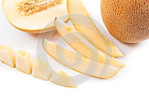 Close up view of whole, half and sliced honeydew melon tropical fruit isolated on a white background