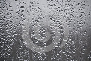 Close-up view of a window covered with raindrops