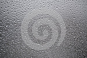 Close-up view of a window covered with raindrops