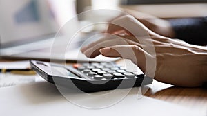 Close up view of woman calculate on machine managing finances