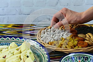 Close-up view, woman hands taking some oriental sweets, Samarkand, Uzbekistan