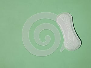 Close up view of woman`s sanitary pad on color back. Top view