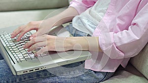 Close up view of womans hand keyboarding on laptop,