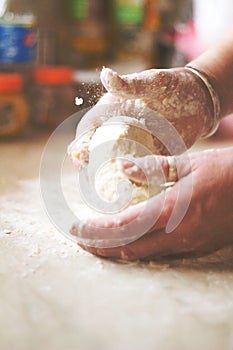 Close Up View Of women kneading yeast dough for long loaf bread