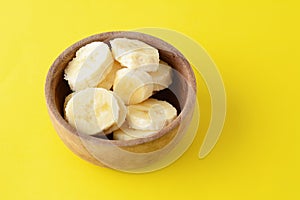 Close up view of wooden bowl with banana slices