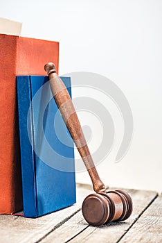 Close-up view of wooden mallet of judge and books on wooden table
