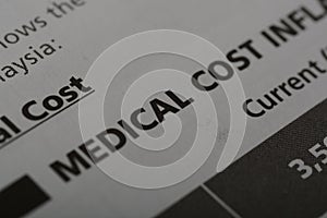 Close-up view of the word MEDICAL COST. Medical cost refers to the expenses incurred for healthcare services and treatments