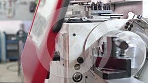 Close up view of worker operating a high precision turning operation on a multi axis lathe, CNC machine tool.