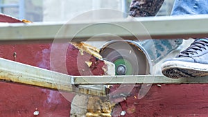 Close-up view of a worker working with angle grinder. Electric wheel grinding on steel structure. Sparks.