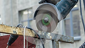 Close-up view of a worker working with angle grinder. Electric wheel grinding on steel structure. Sparks.