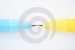Close up view of yellow and blue pencils isolated on white.