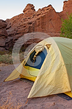 Close up view of yellow camping tent in southwestern desert canyon in San Lorenzo Canyon, New Mexico, USA