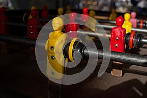 Close up view of a yellow player on a football toy.