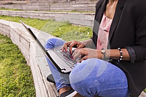 Close up view of a young afro American woman using laptop. Green