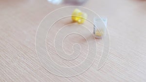 Close up view of young woman holding ginseng vitamins and minerals pills in hand and taking glass of water