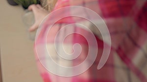 Close up view of young woman holding ginseng vitamins and minerals pills in hand and taking glass of water. High angle